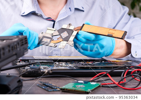 Hands fixing motherboard of pc or laptop notebook close up in service. Laptop repair service. Hands fixing motherboard of pc or laptop notebook close up in service. Laptop repair service. 95363034