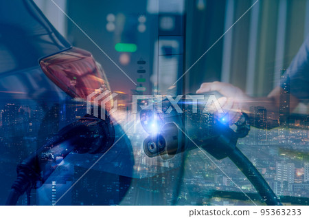 Car charging at electric car charging station and city night lights background. Hand holding EV charger for charge EV battery. Clean and sustainable energy. Sustainable city. Electric vehicle and city 95363233