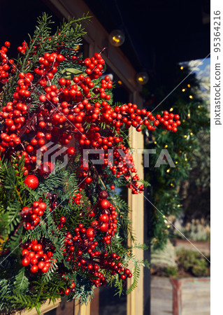 New Year and Christmas decorative wreath on the door. Vertical photo. New Year and Christmas decorative wreath on the door. Vertical photo. 95364216