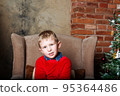 Caucasian boy sitting on chair. Christmas time. 95364486