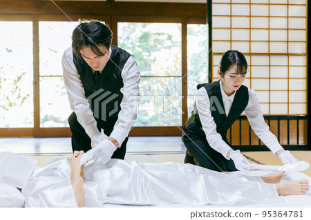 Funeral staff wearing Buddhist garments (Nōkanshi) 95364781