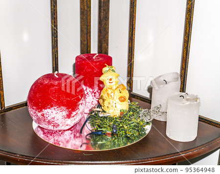 Christmas decoration from candles and fir branches. 95364948