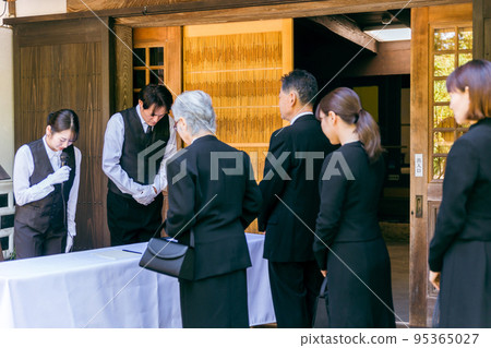 Funeral Director (Moderator) Bowing at the Funeral Reception Funeral Director (Moderator) Bowing at the Funeral Reception 95365027
