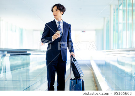 年輕商人在辦公室大堂打電話給智能手機 95365663