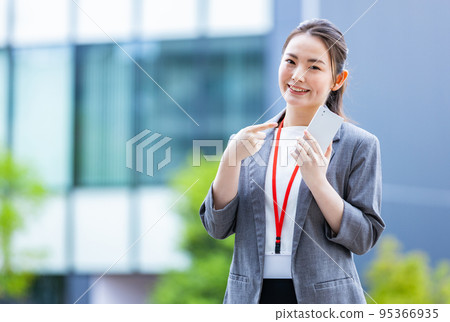 拿著智能手機的微笑的女商人 95366935