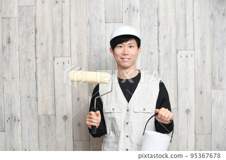 Worker with paint roller and bucket Worker with paint roller and bucket 95367678