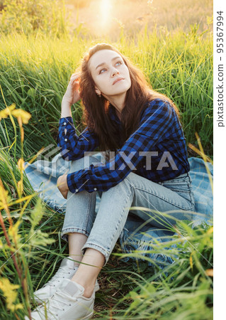 Portrait of a beautiful young woman on meadow Portrait of a beautiful young woman on meadow 95367994