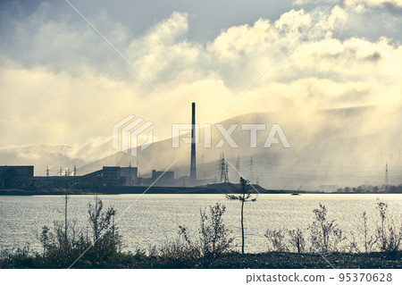 Industrial landscape with heavy pollution produced by a large factory. 95370628