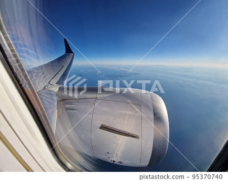 View of blue sky from airplane window View of blue sky from airplane window 95370740