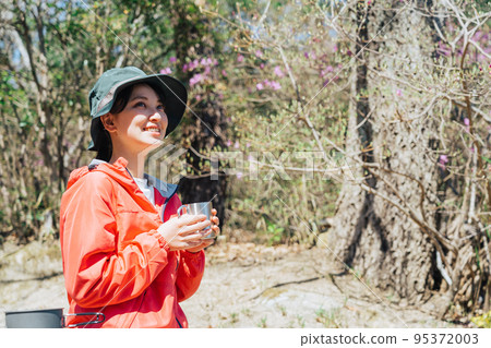 Woman drinking coffee in nature 95372003