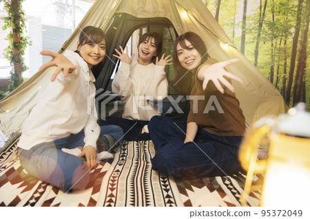 Young women enjoying home camping Ie Camp 95372049