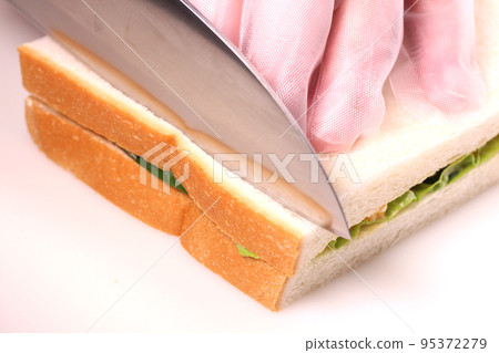 Sandwich making: Cut the ears of bread Sandwich making: Cut the ears of bread 95372279