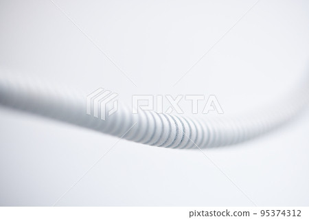 white plastic corrugated pipe on white background 95374312
