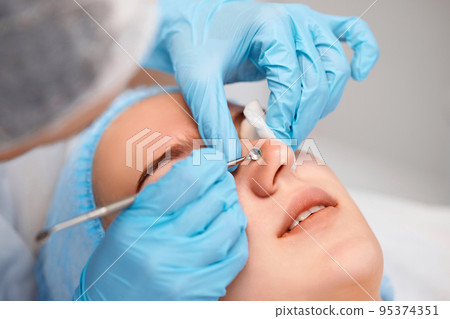 woman during a mechanical face cleansing procedure woman during a mechanical face cleansing procedure 95374351