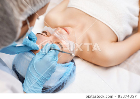 woman during a mechanical face cleansing procedure 95374357