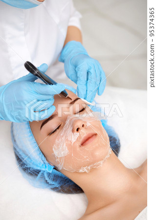 face of woman while procedure ultrasonic cleansing face of woman while procedure ultrasonic cleansing 95374365
