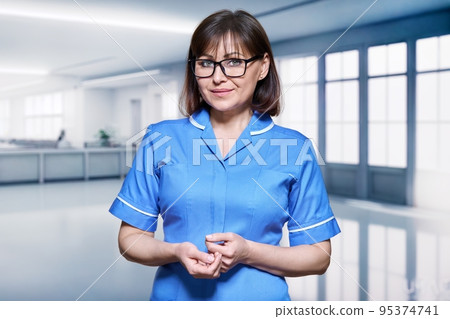 Portrait of a female nurse inside the hospital Portrait of a female nurse inside the hospital 95374741