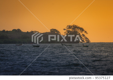 Fishing boats in the middle of the lake at sunset. Lake Victoria,Tanzania. 95375127