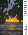 Sun framed between leaves and tree branches, at sunset. Lake Victoria,Tanzania. 95375143