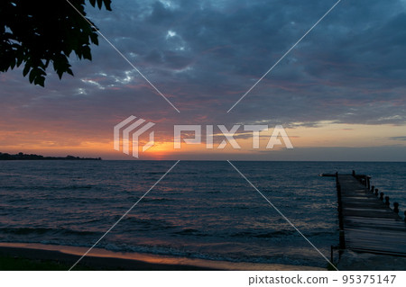Wooden boat dock at sunset. Lake Victoria,Tanzania. Wooden boat dock at sunset. Lake Victoria,Tanzania. 95375147