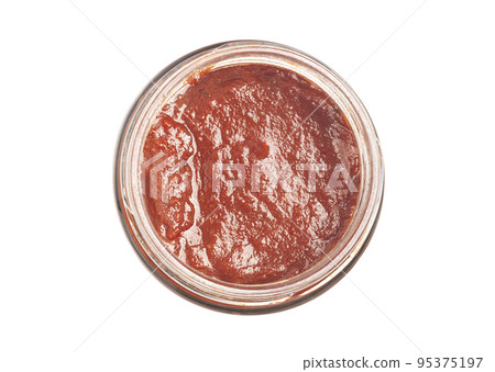 Tomato paste in a glass bowl top view isolated on white. 95375197