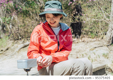 Woman cooking in Mestin Woman cooking in Mestin 95375405
