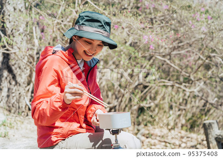 Woman cooking in Mestin 95375408