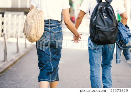 men and women walking hand in hand 95375829