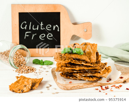 Gluten-free crispbreads on white wooden bg Gluten-free crispbreads on white wooden bg 95375914