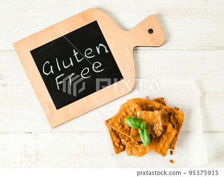 Gluten-free crispbreads on white wooden bg Gluten-free crispbreads on white wooden bg 95375915