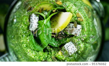 Green fresh smoothie blended in blender, top view. Healthy eating concept. 95376082