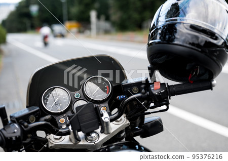 A cool bike parked on the shoulder A cool bike parked on the shoulder 95376216