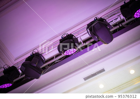 Light heads beam and fill hang on a truss above the ceiling in event hall Light heads beam and fill hang on a truss above the ceiling in event hall 95376312
