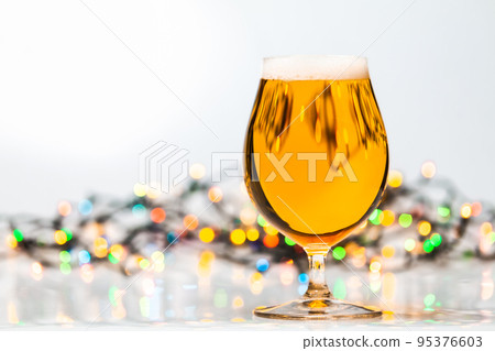 Tulip glass of beer with christmas lights 95376603