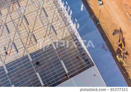 Under construction warehouses on building site there is metal steel framework Under construction warehouses on building site there is metal steel framework 95377321