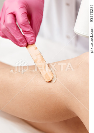 Laser depilation or photoepilator process on a woman leg. Laser depilation or photoepilator process on a woman leg. 95378285