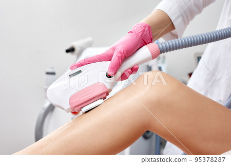 Laser depilation or photoepilator process on a woman leg. Laser depilation or photoepilator process on a woman leg. 95378287