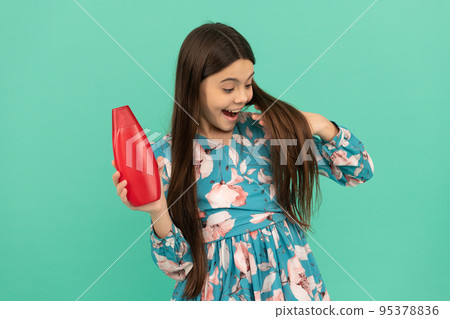 child with hair conditioner. daily habits and personal care. beauty skincare and haircare. child with hair conditioner. daily habits and personal care. beauty skincare and haircare. 95378836