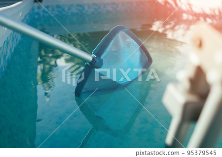 Cleaner of the swimming pool. Cleaning equipment for swimming pools, sunny day Cleaner of the swimming pool. Cleaning equipment for swimming pools, sunny day 95379545