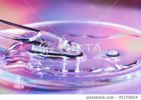 Pipette with sample of cosmetic product in petri dish on holographic background, iridescent highlights, selective focus 95379924