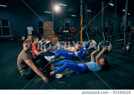 Young, sportive and motivated. Group of young friends doing sports, training at gym indoors. Sport achievements, challenges, hobbies, leisure activities Young, sportive and motivated. Group of young friends doing sports, training at gym indoors. Sport achievements, challenges, hobbies, leisure activities 95380026