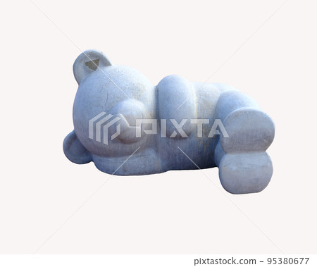 A concrete sculpture of a sleeping bear on a white background 95380677