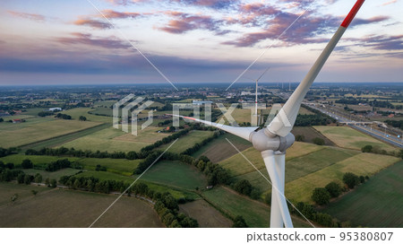 Wind turbines on beautiful sunny summer purple autumn rural agraric landscape. Green ecological 95380807