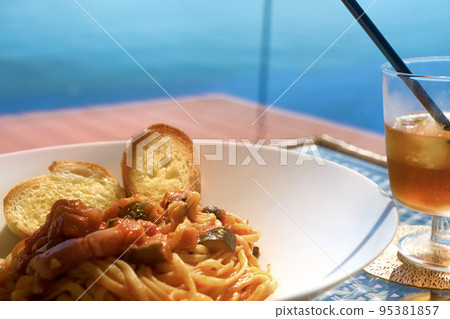 Seaside terrace lunch pasta caponata horizontal composition Seaside terrace lunch pasta caponata horizontal composition 95381857