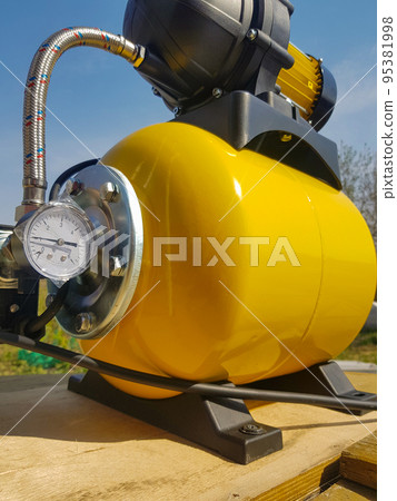 New water pumping station, household automatic station with pressure sensor, yellow color. Application of house, country house, village, cottage New water pumping station, household automatic station with pressure sensor, yellow color. Application of house, country house, village, cottage 95381998