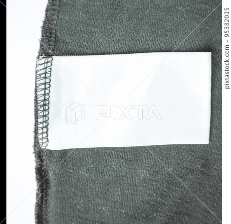 Empty empty clothing label for laundry information on the background of a black knitted jacket 95382015