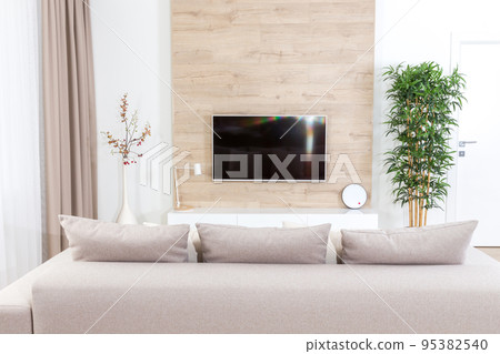 Living room with couch and led tv on wooden wall 95382540