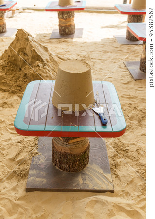 Sand castle made by kids on a craft lesson on beach Sand castle made by kids on a craft lesson on beach 95382562