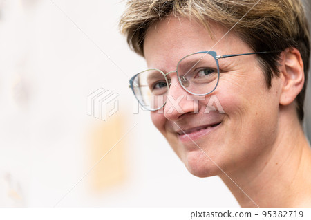 Portrait of a short haired white 35 yo woman looking sideways Portrait of a short haired white 35 yo woman looking sideways 95382719