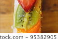 Fasting cake with tangerines, kiwi and strawberry. Macro and slider shooting 95382905